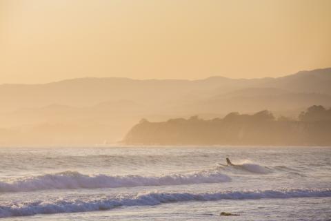 Surfer at dusk off Campus Point